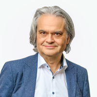 Michael Chauvistré Portrait eines Herrn mit kinnlangem, grauen Haar, weißem Hemd und blauem Jackett.